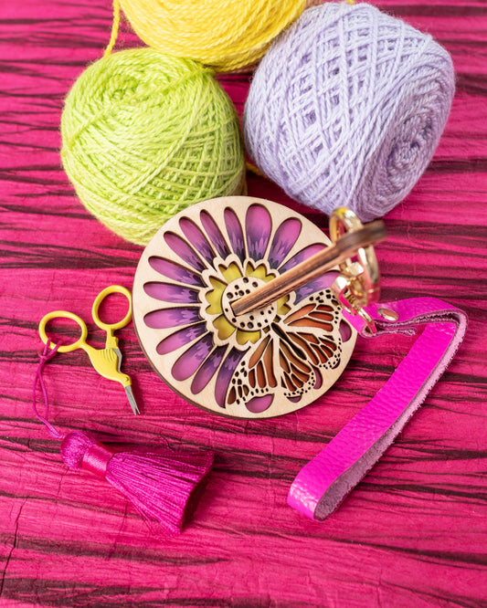 lemonwood monarchana yarn accessory wooden butterfly yarn minder with pastel yarn balls and pink tassel