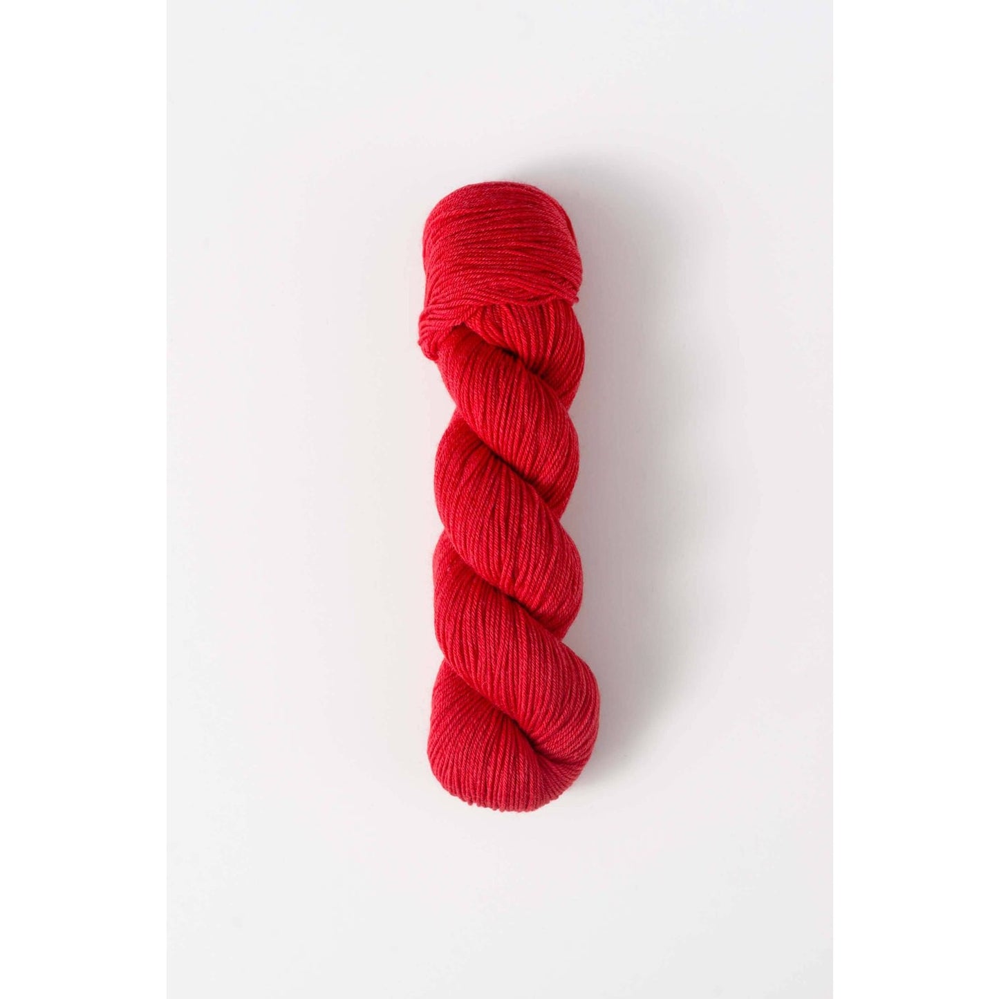 Quince & Co. superwash merino fingering yarn in vibrant red color skein