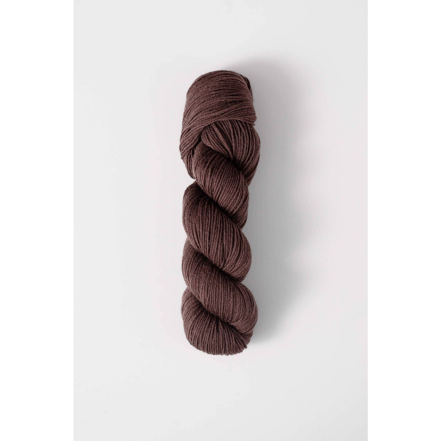 Quince and Co superwash merino fingering yarn in rich brown color skein