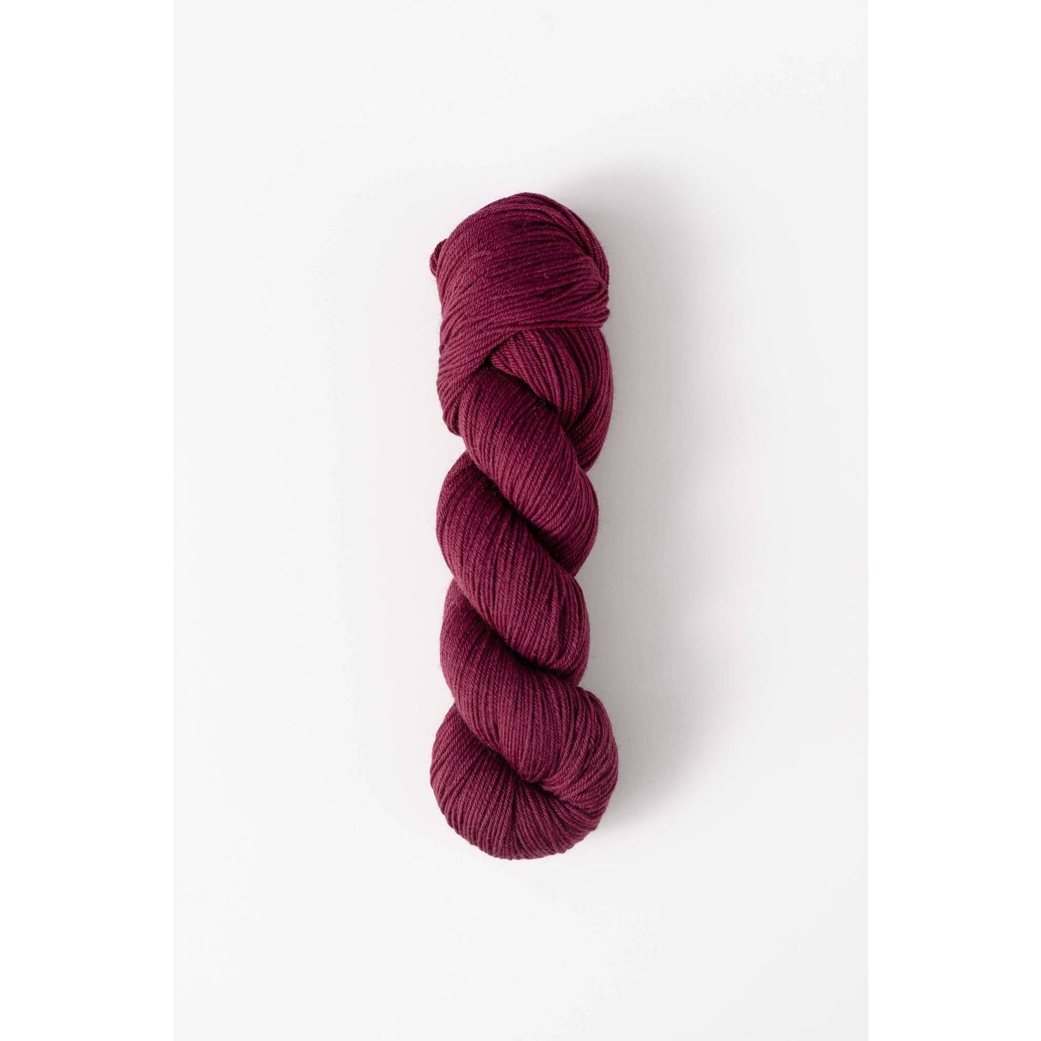 Quince & Co. superwash merino fingering yarn in deep berry color skein for knitting and crochet