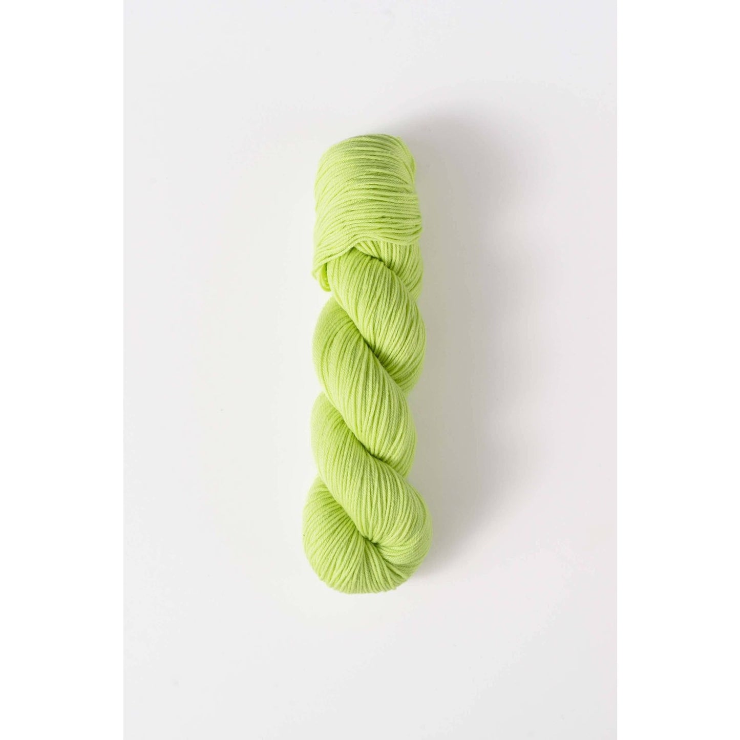 Quince & Co. superwash merino fingering yarn in light green shade twisted skein