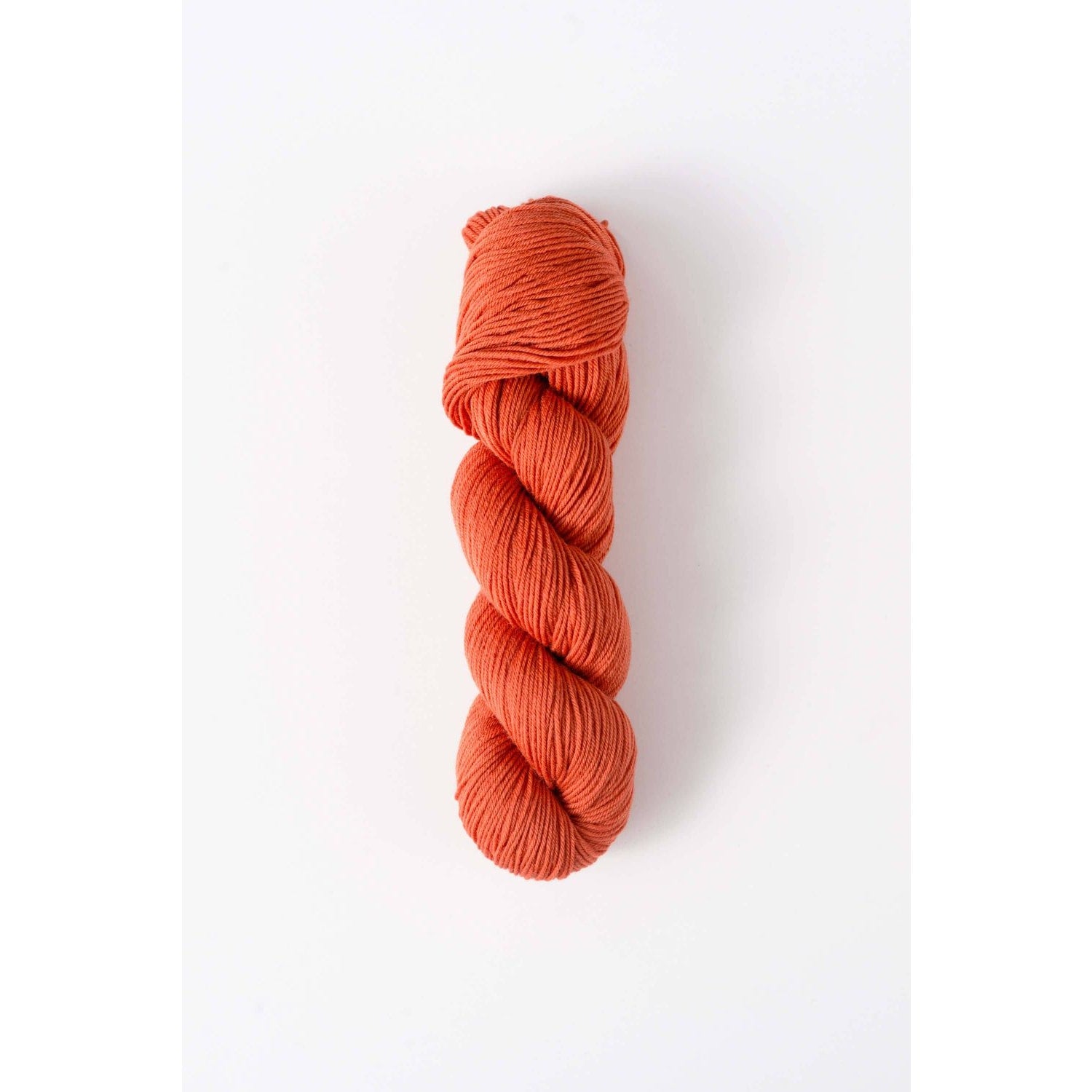 Quince & Co. orange skein of superwash merino fingering yarn for knitting and crocheting