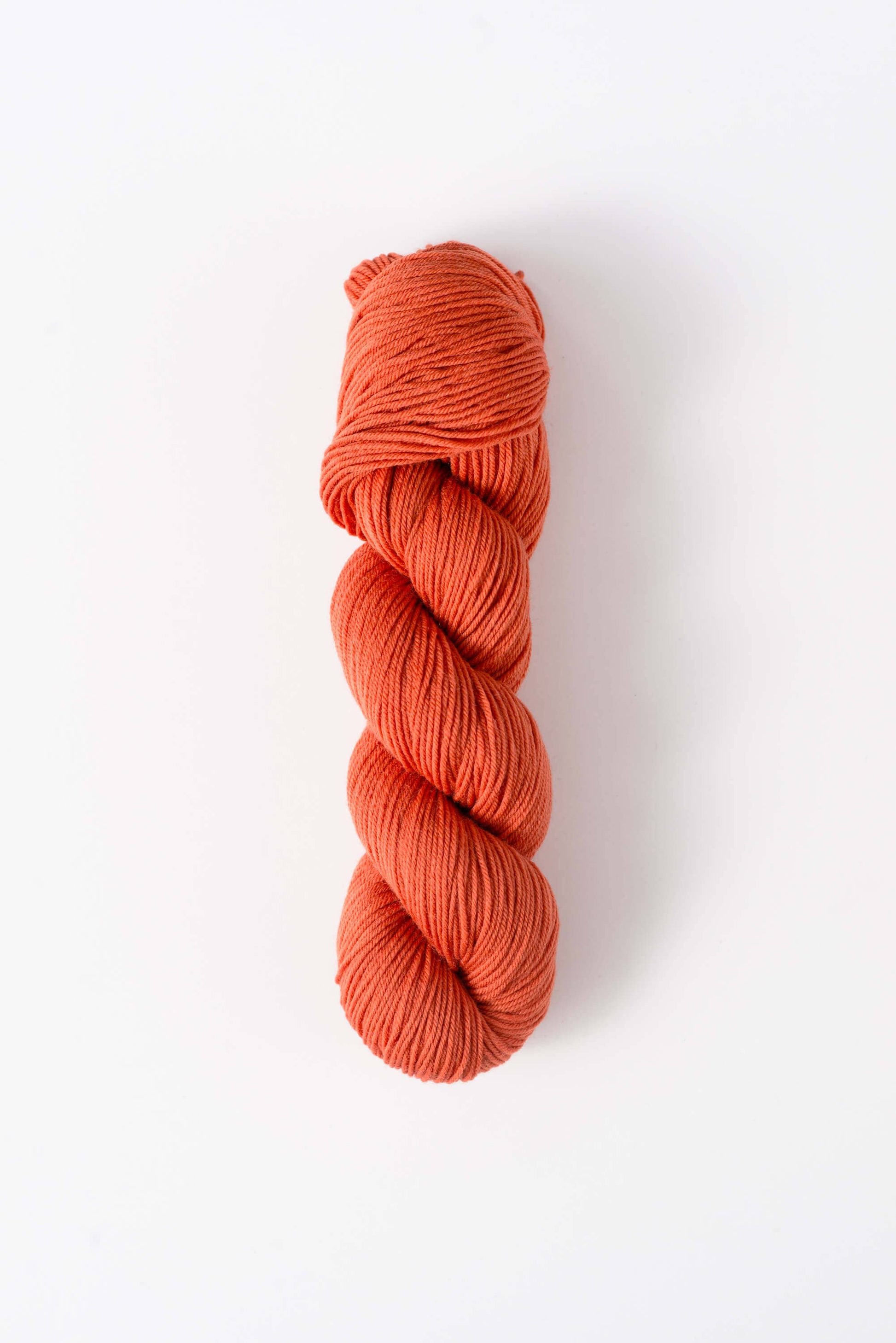 Quince & Co. orange skein of superwash merino fingering yarn for knitting and crocheting