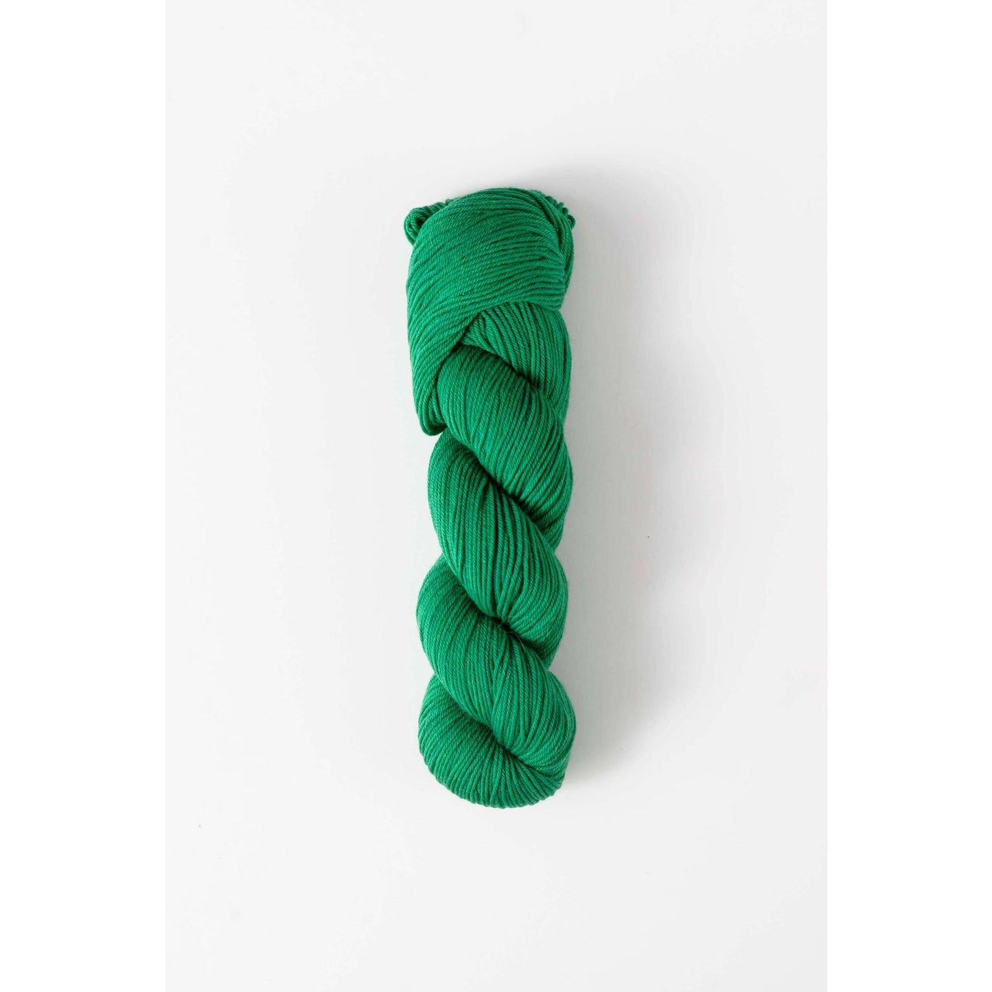 Quince & Co. superwash merino fingering yarn in vibrant green skein for knitting and crocheting