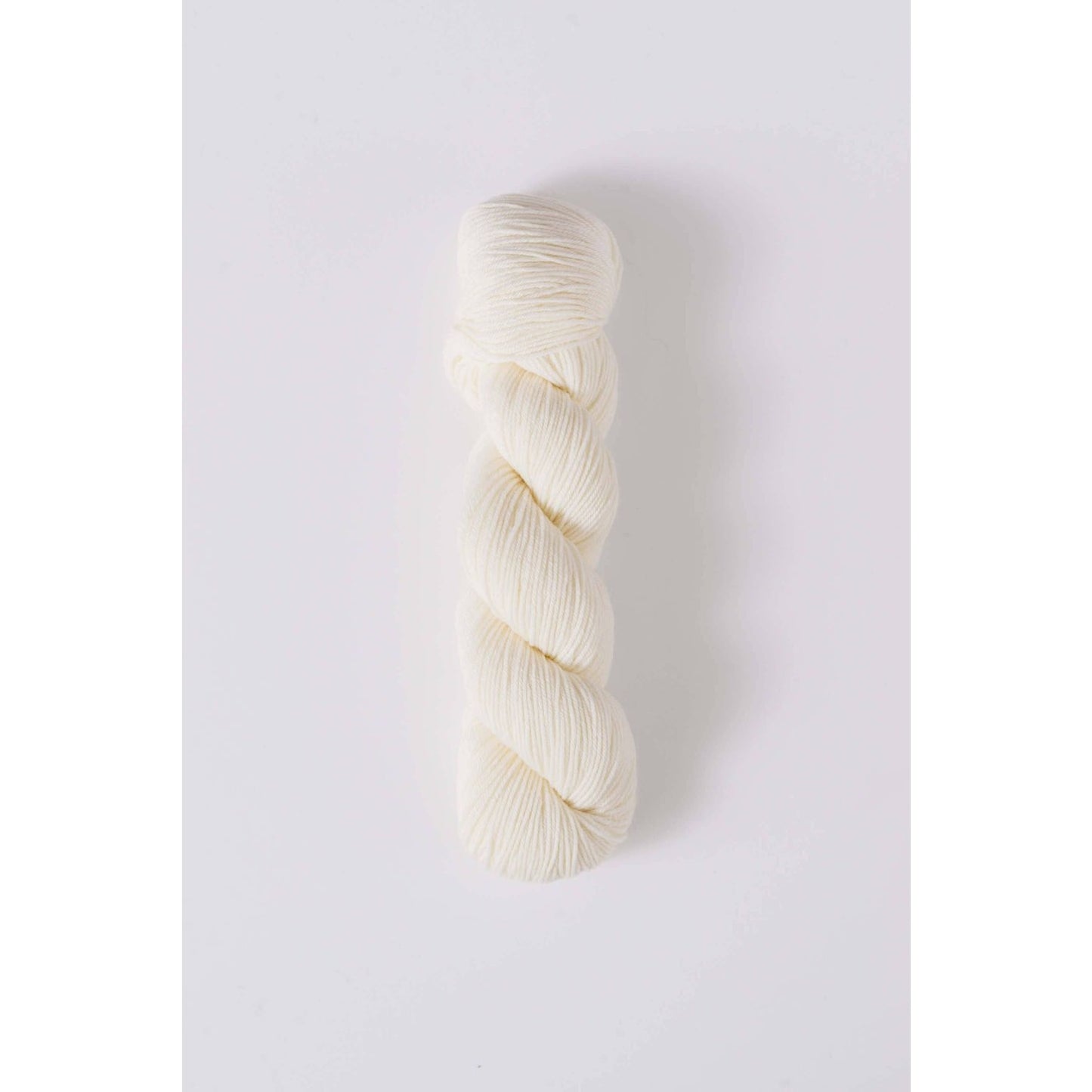 Quince & Co. white superwash merino fingering yarn skein for knitting and crochet projects
