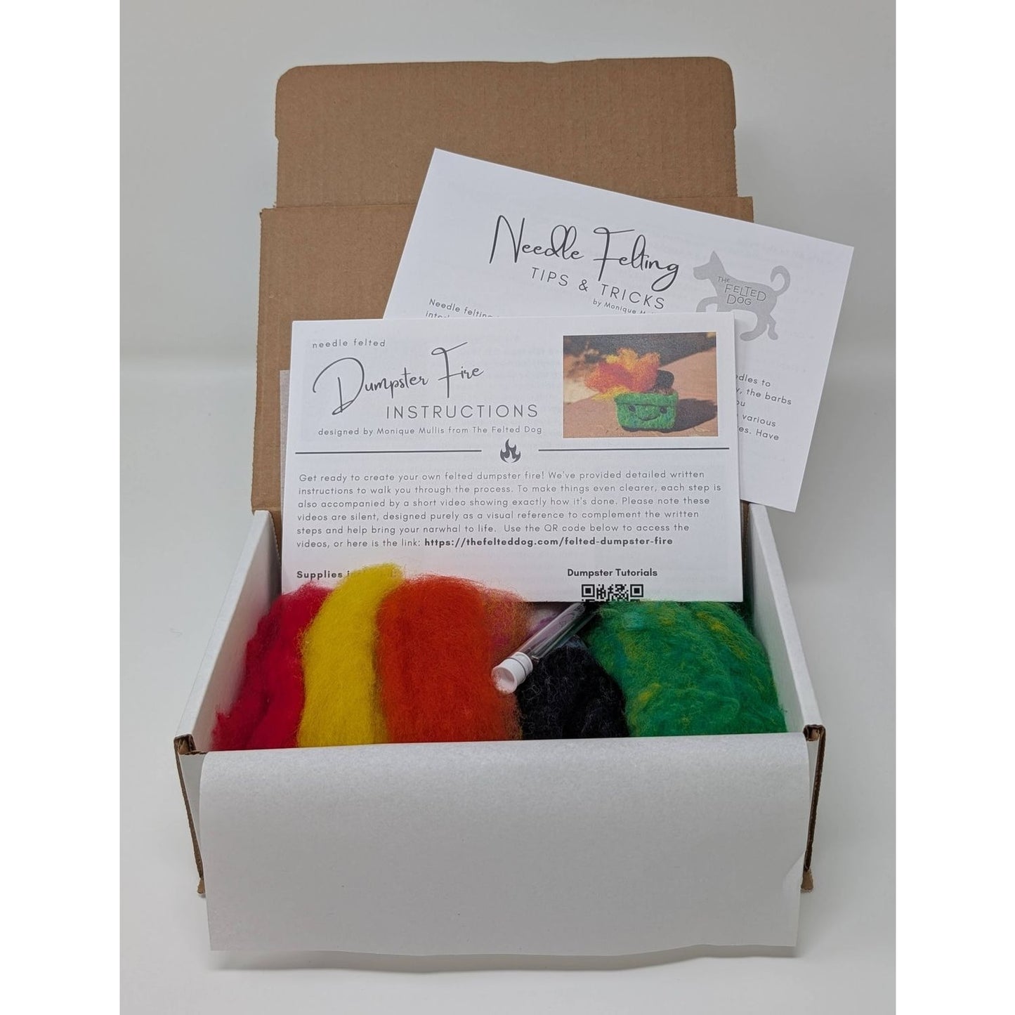 Needle felting needles kit from The Felted Dog with colorful wool and instructions for crafting.