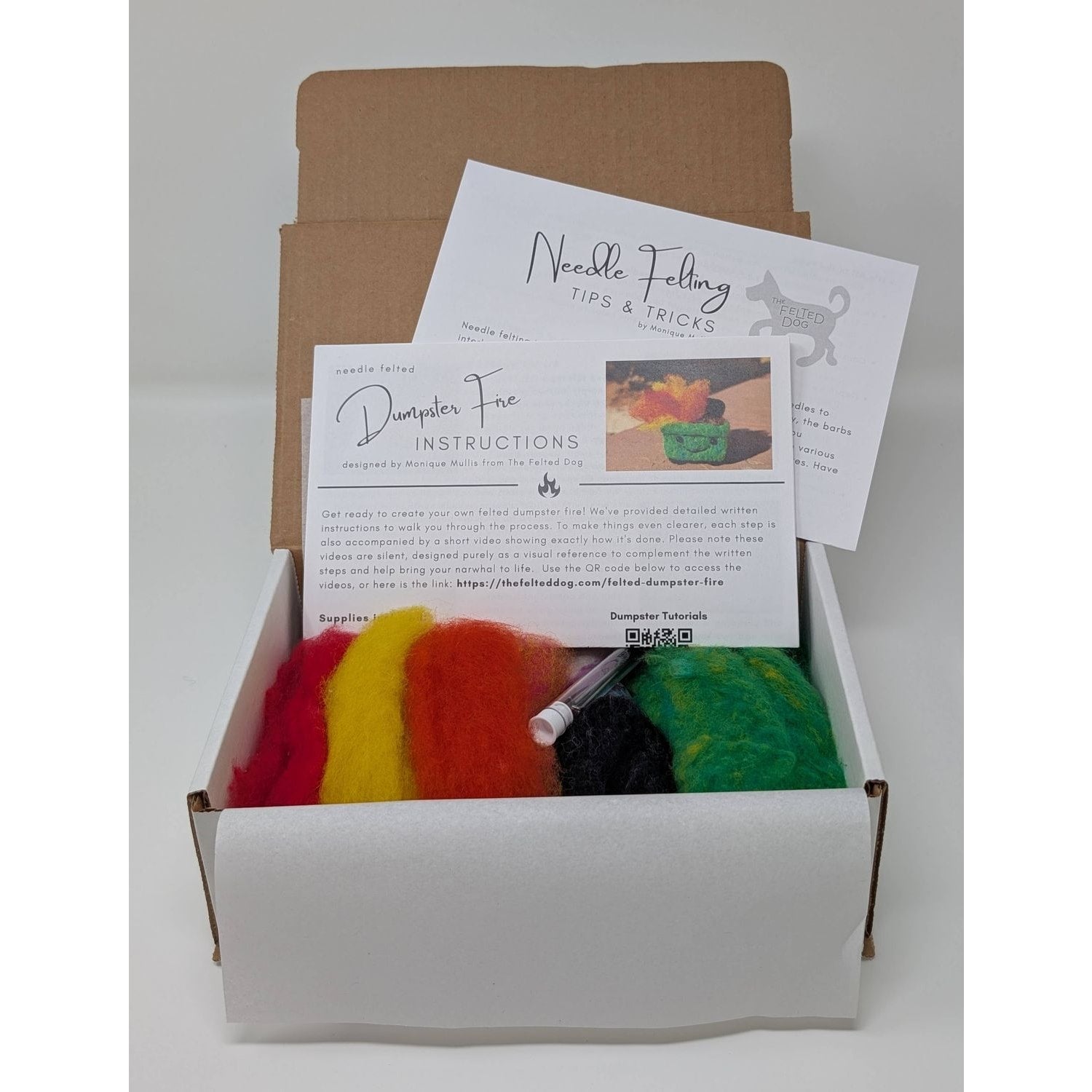 Needle felting needles kit from The Felted Dog with colorful wool and instructions for crafting.