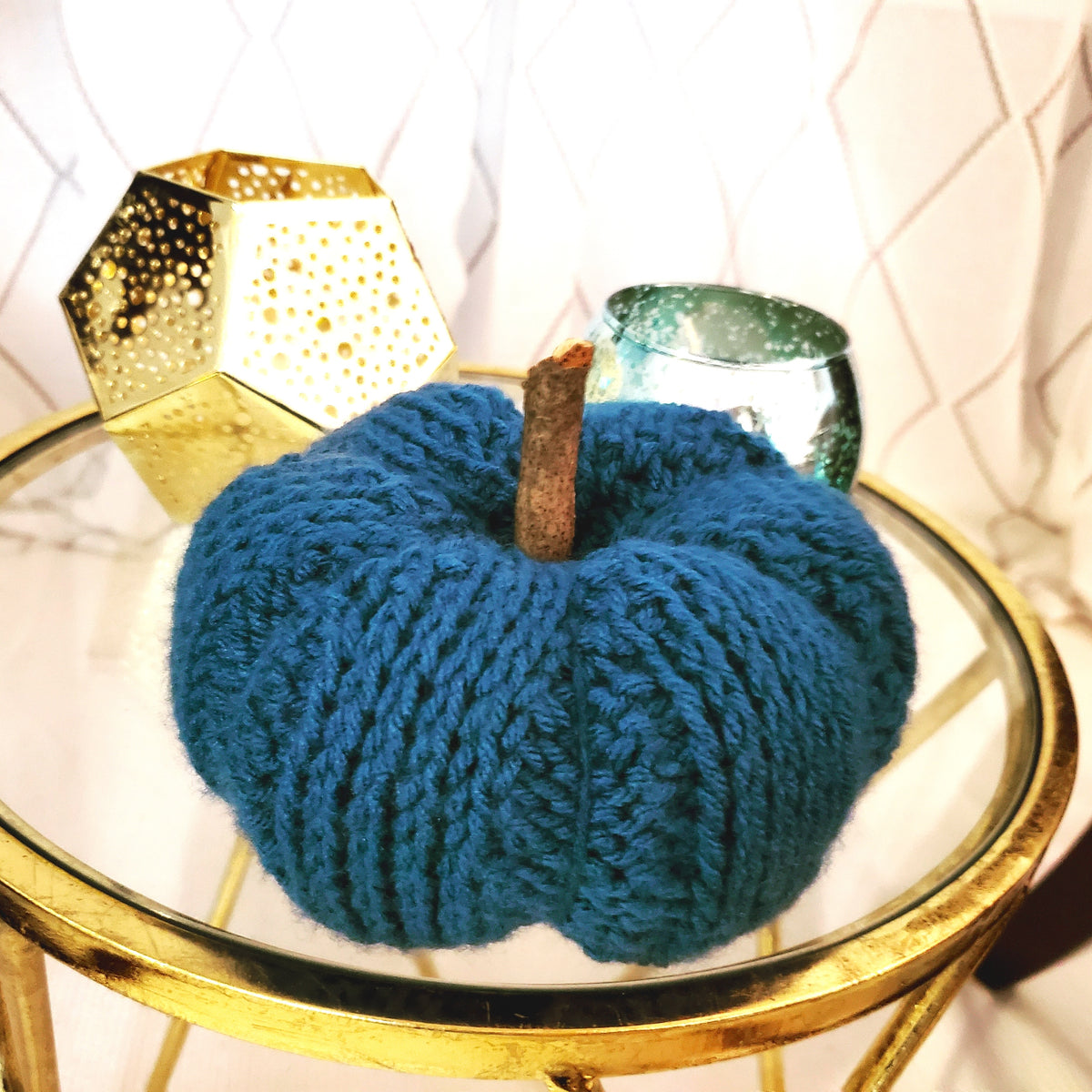 Tunisian crochet pumpkin workshop featuring a blue yarn pumpkin centerpiece with decorative accents