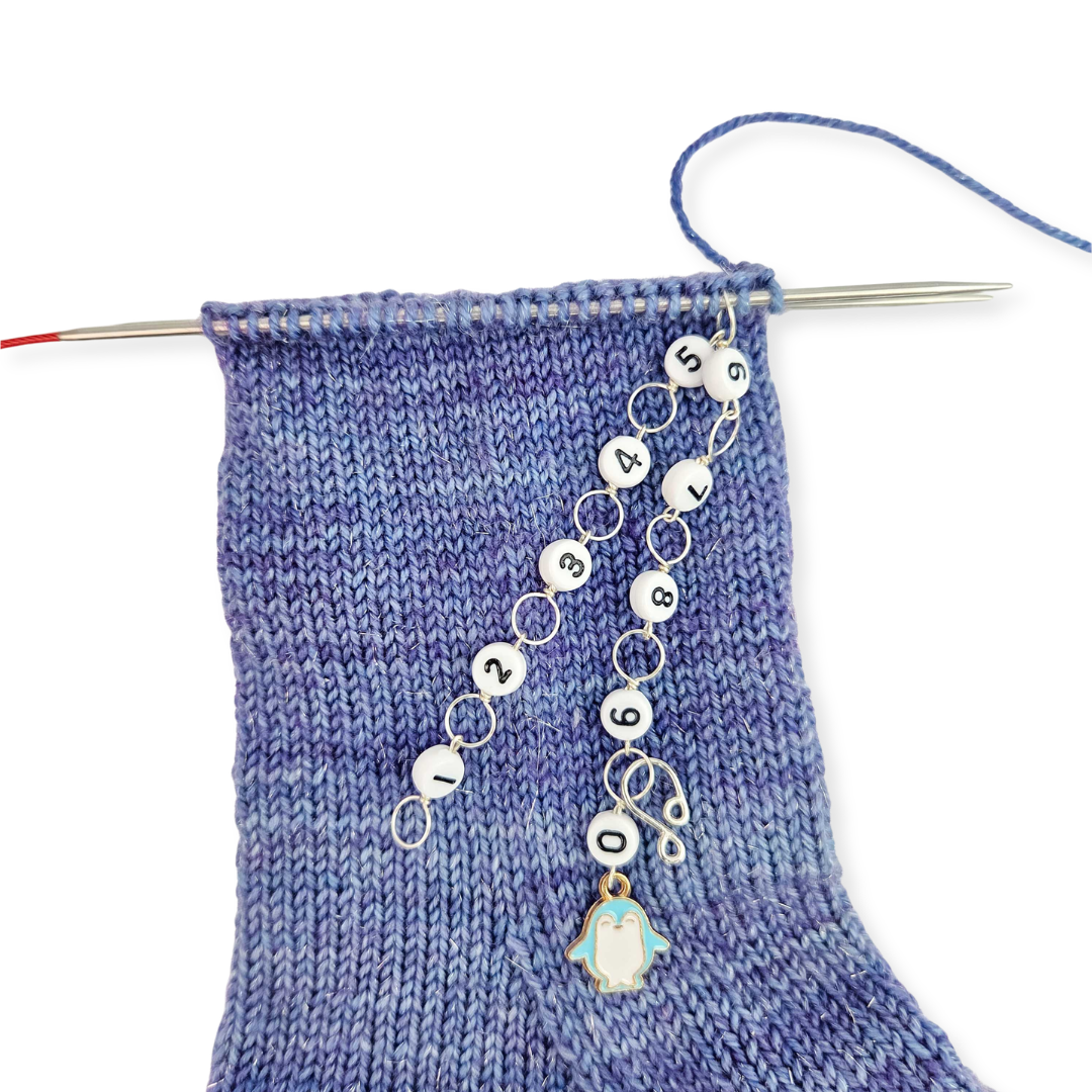 Twice Sheared Sheep yarn project with stitch markers in purple tones, perfect for a gift box with gift.