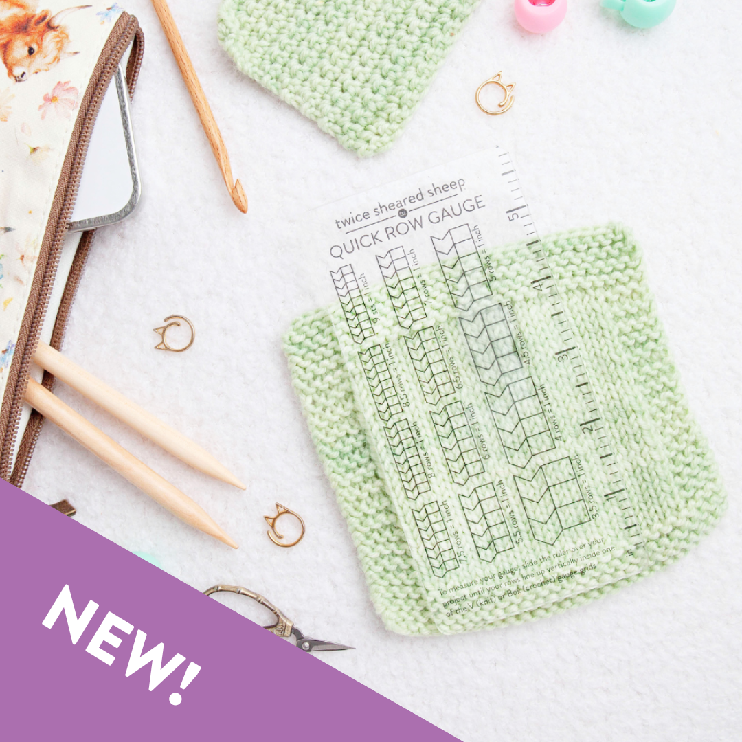 Twice Sheared Sheep knit gauge ruler laid over green knit swatches for precise measuring