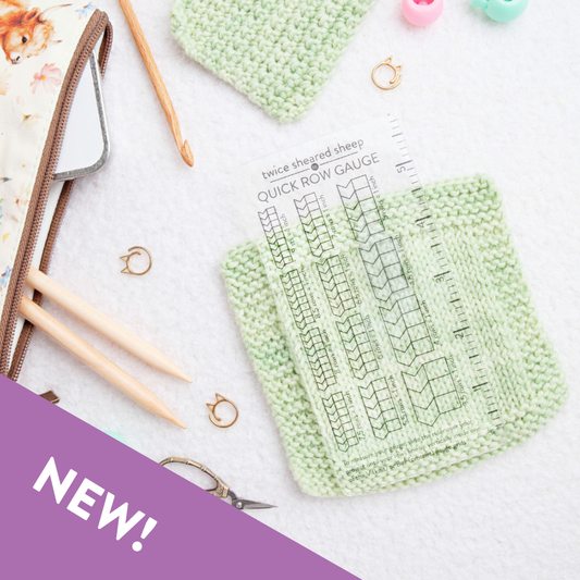 Twice Sheared Sheep knit gauge ruler laid over green knit swatches for precise measuring