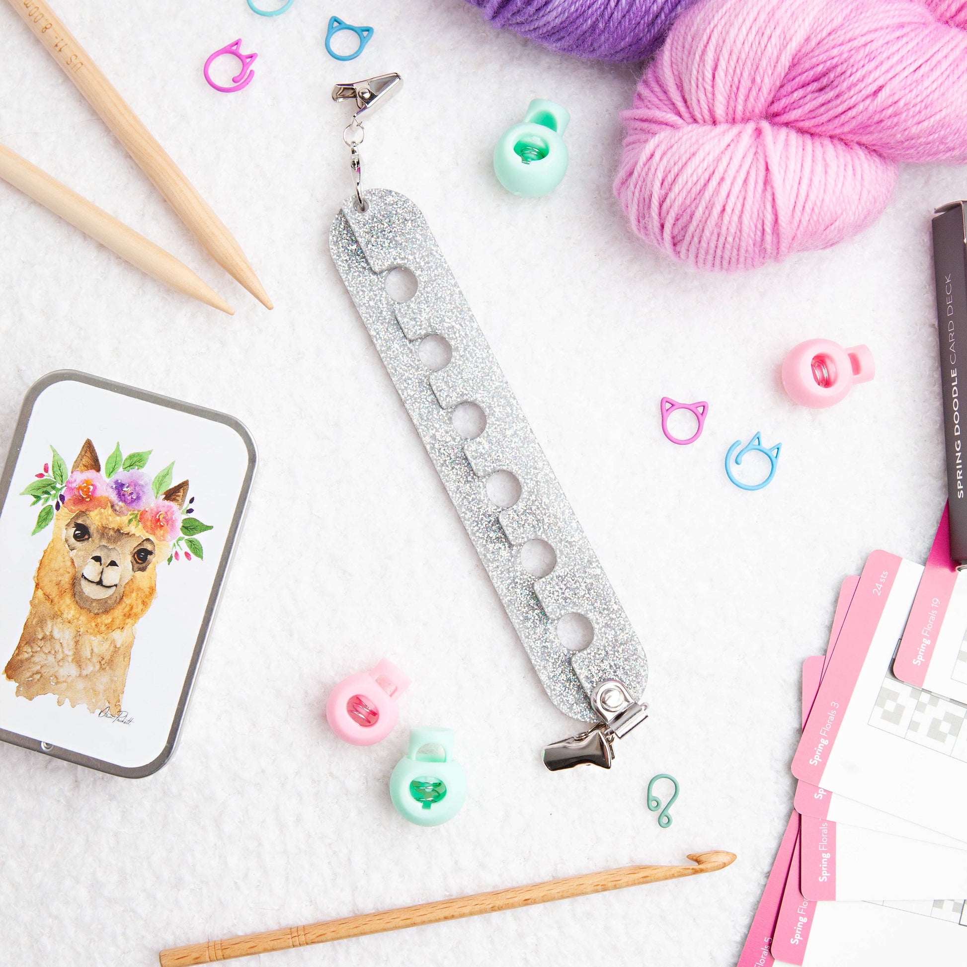 Twice Sheared Sheep glittery yarn guide with colorful stitch markers and pink yarn for yarn retailers near me