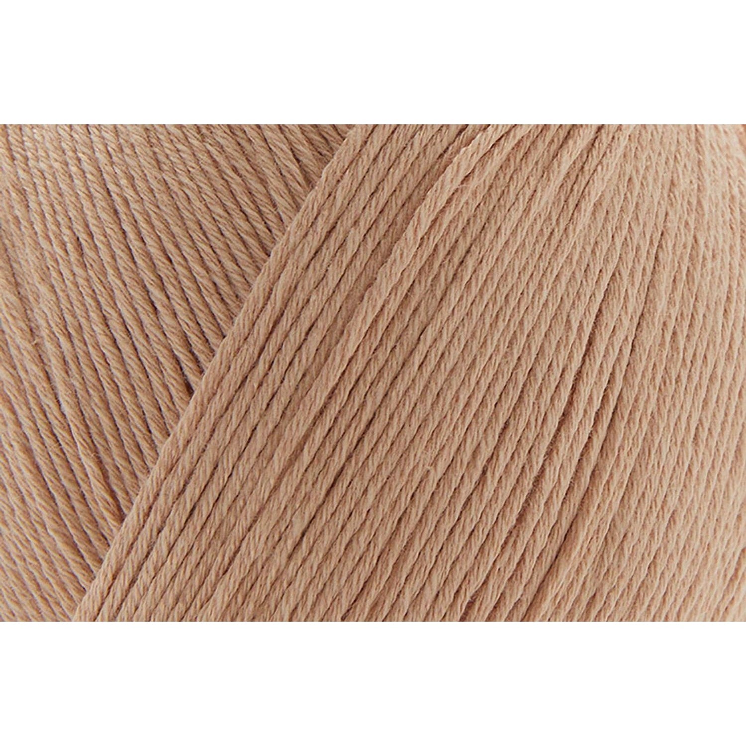 Close-up of Universal Yarn Bamboo Pop in soft peach color, perfect for knitting or crocheting projects