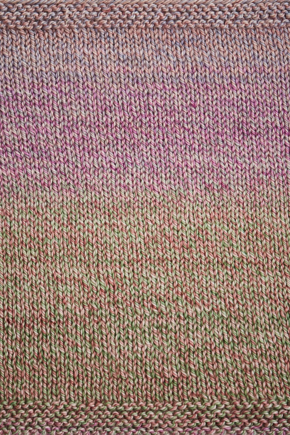 Urth Yarns Spiral Grain Light Worsted showcasing a beautiful gradient pattern in soft colors