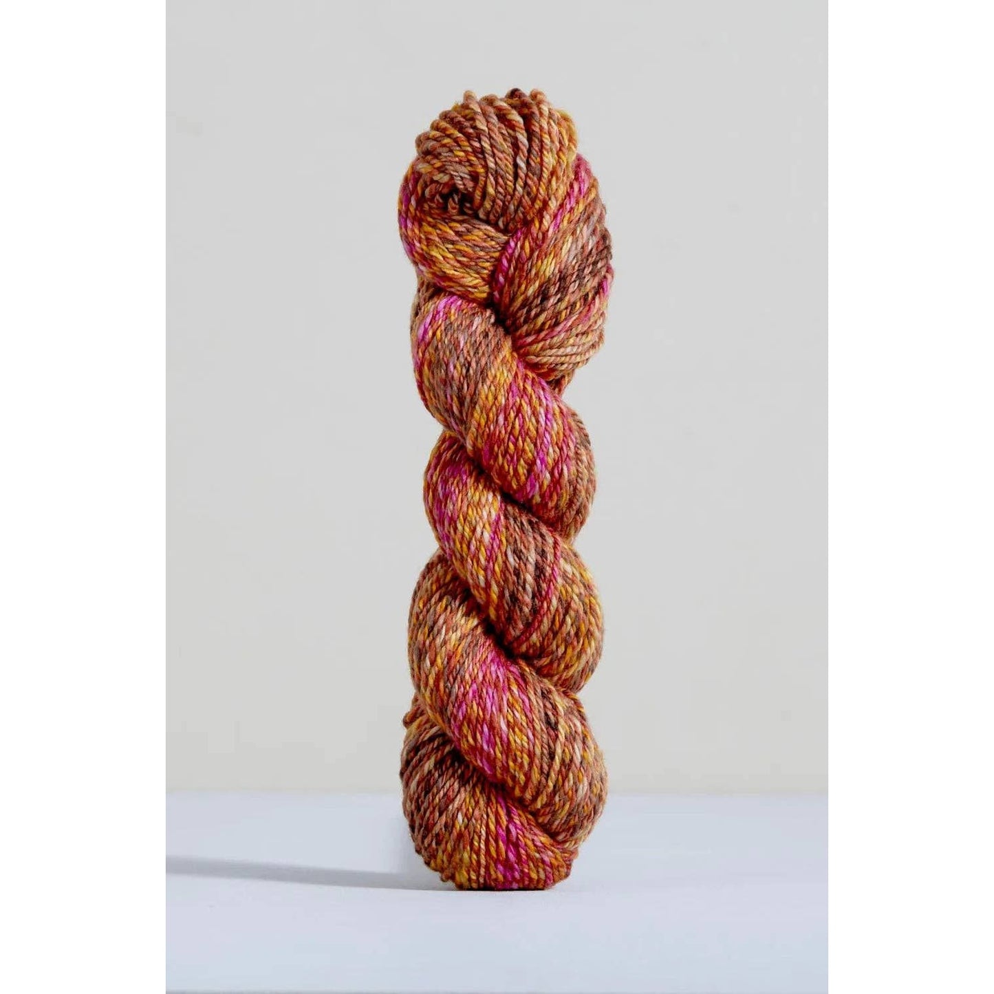 Urth Yarns Spiral Grain Light Worsted Teak with rich orange and pink tones for knitting projects
