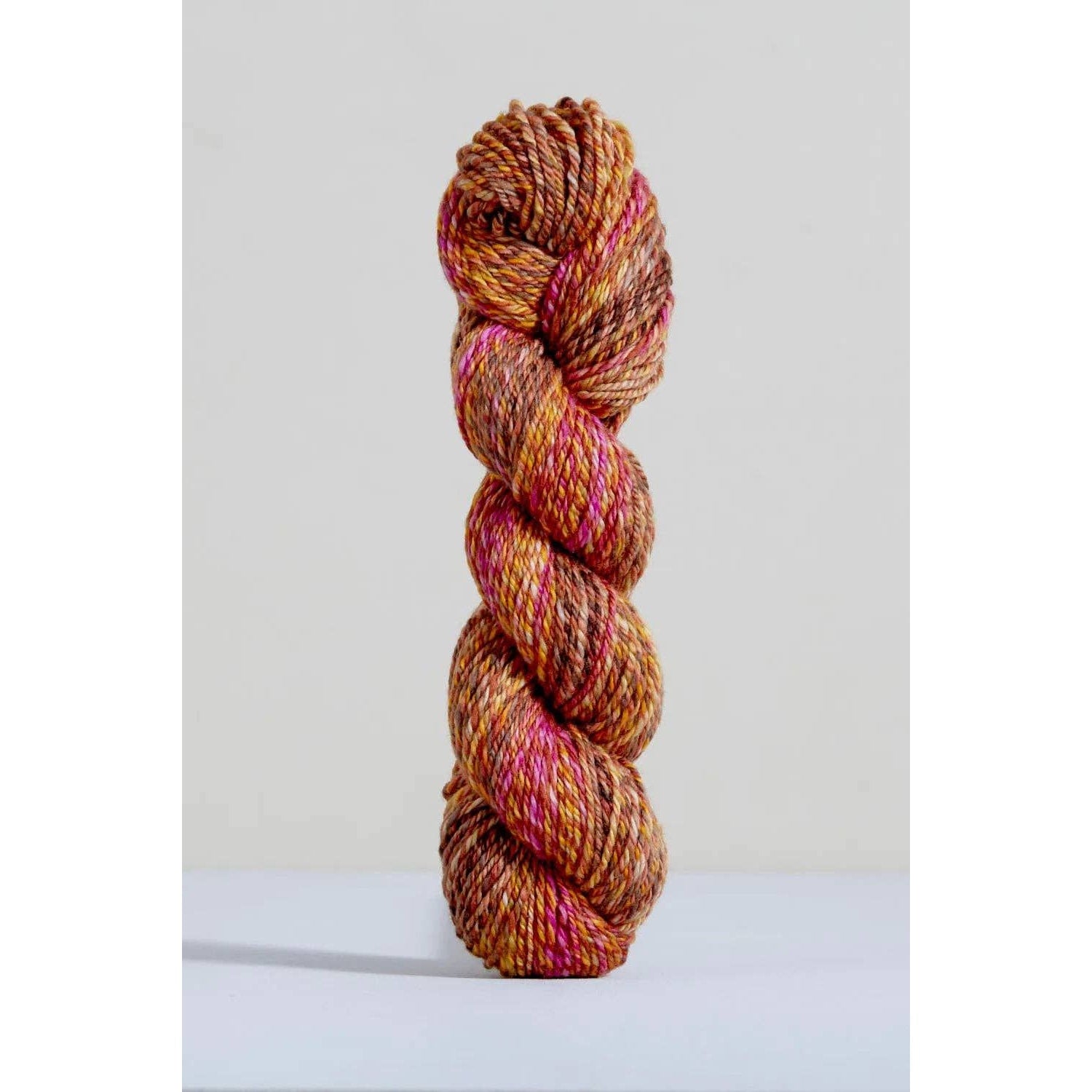 Urth Yarns Spiral Grain Light Worsted Teak with rich orange and pink tones for knitting projects