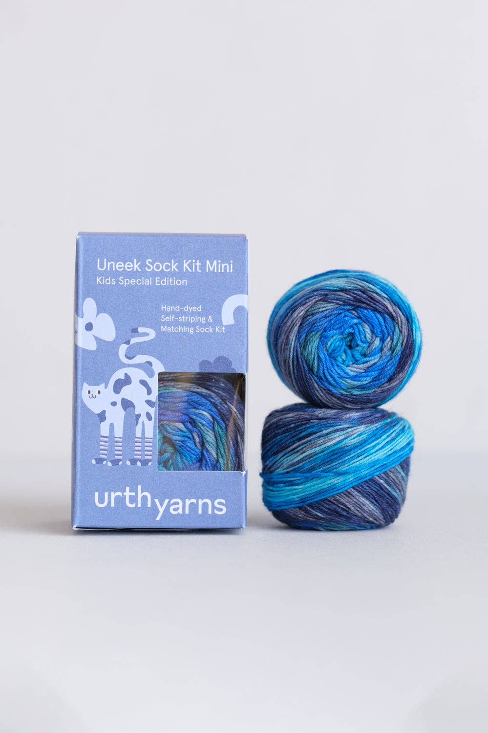 Uneek Sock Kit Mini by Urth Yarns in blue and purple colors for kids, hand-dyed sock knitting kit