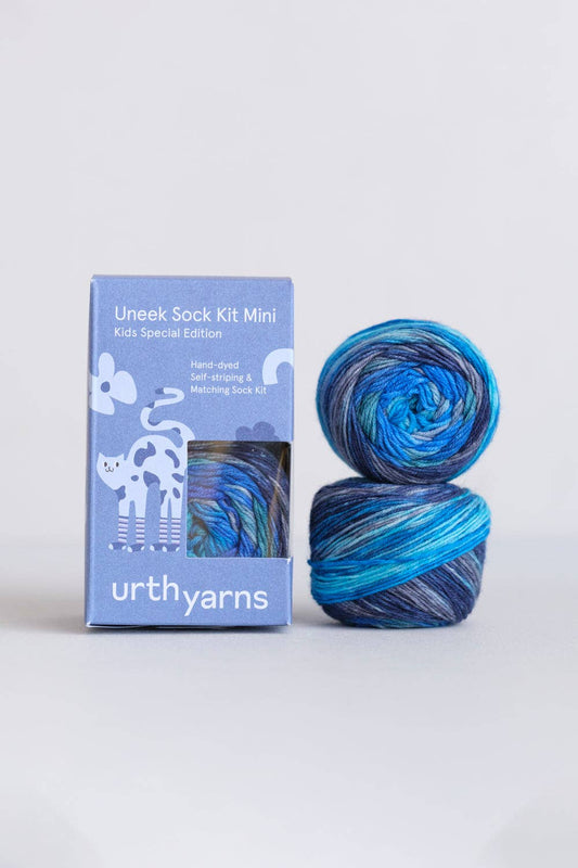 Uneek Sock Kit Mini by Urth Yarns in blue and purple colors for kids, hand-dyed sock knitting kit