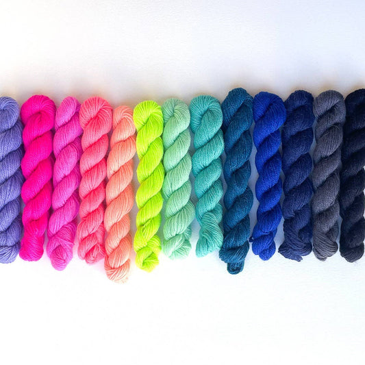 Colorful display of Kelbourne Woolens Perennial Minis yarn in vibrant shades for knitting and crocheting