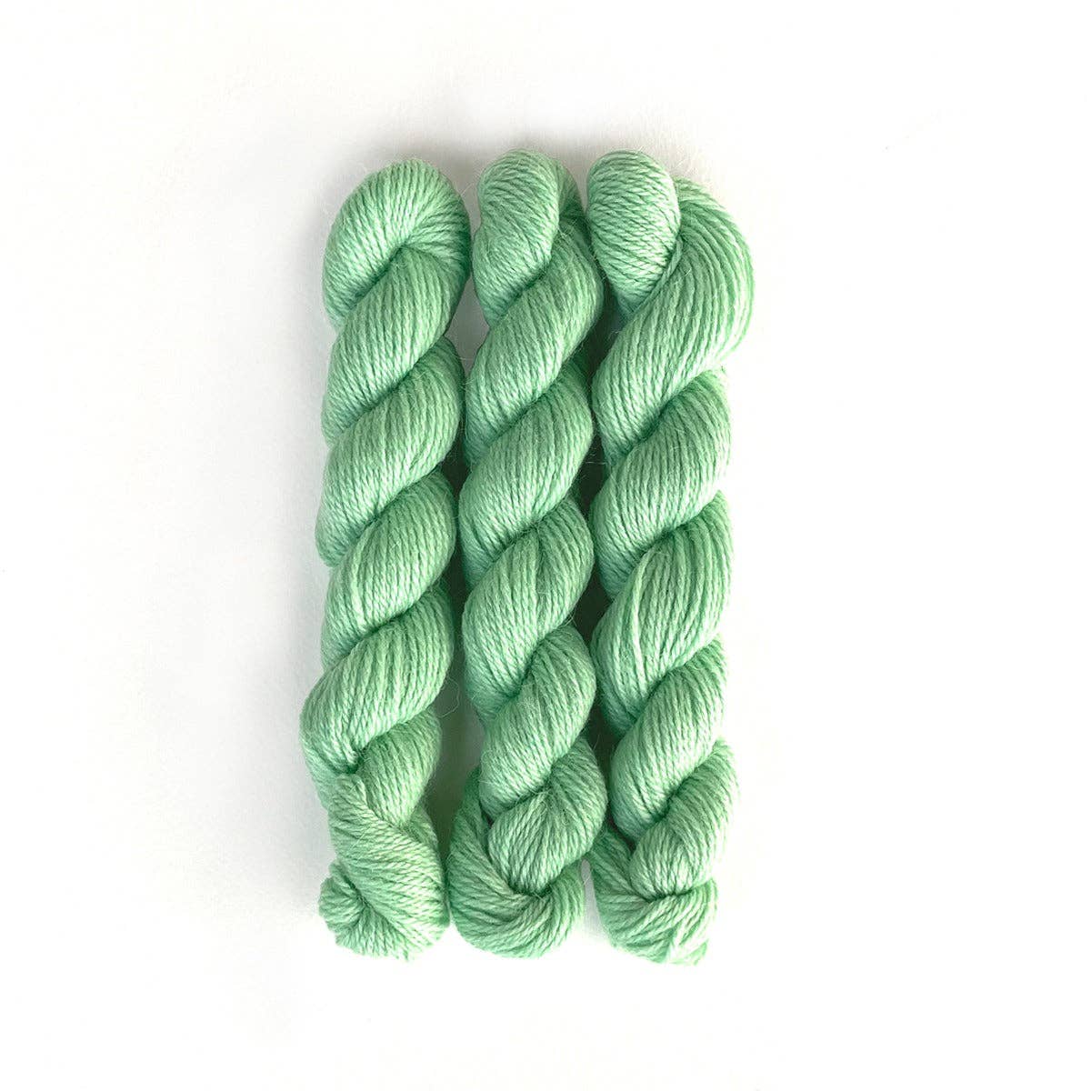 Kelbourne Woolens Perennial Minis yarn in soft green color, perfect for knitting and crocheting projects