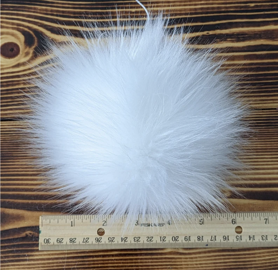 Fluffy white pom pom for knitting hats, perfect for adding style to winter accessories