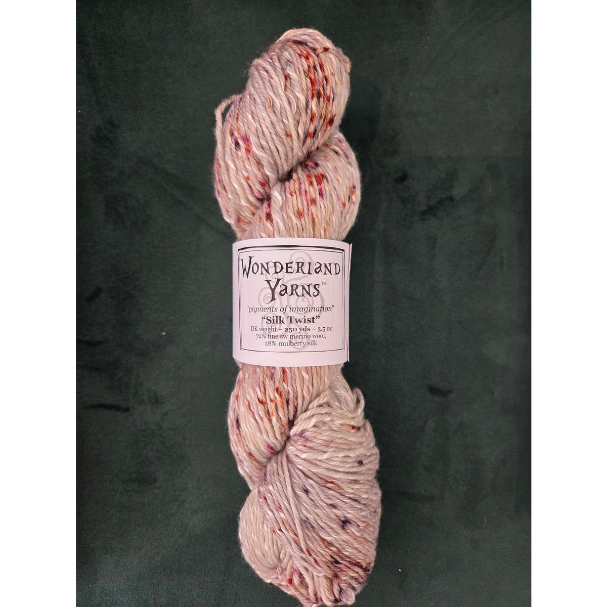Wonderland Yarns Silk Twist in Soft Pink with Multicolored Flecks, perfect for knitting and crocheting projects