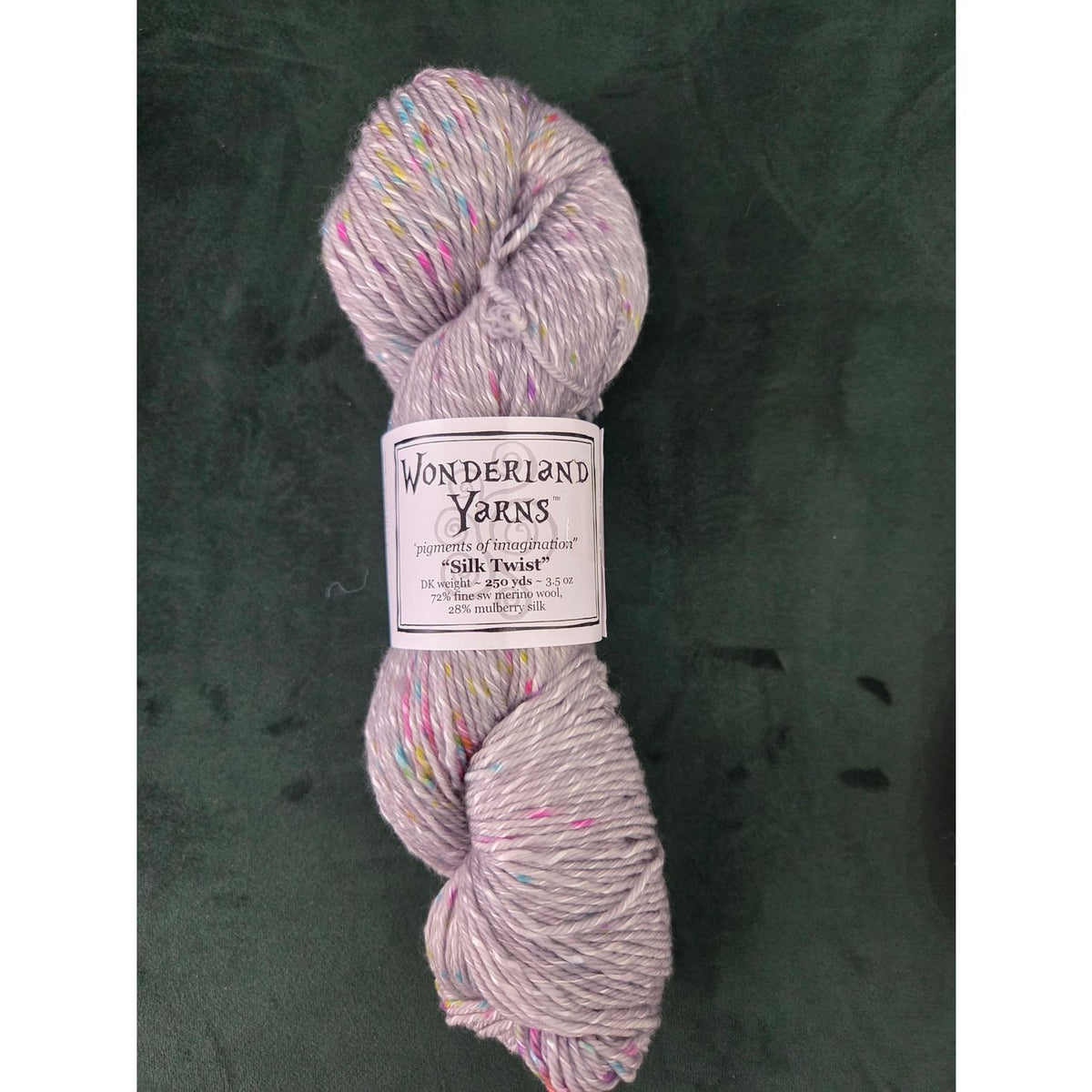 Wonderland Yarns Silk Twist in light gray with colorful specks for knitting and crochet projects