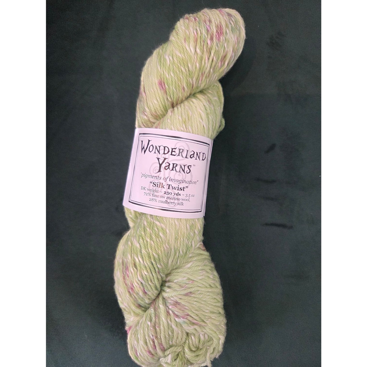 Frabjous Fibers Wonderland Yarns Silk Twist in soft green with pink flecks for knitting and crocheting projects