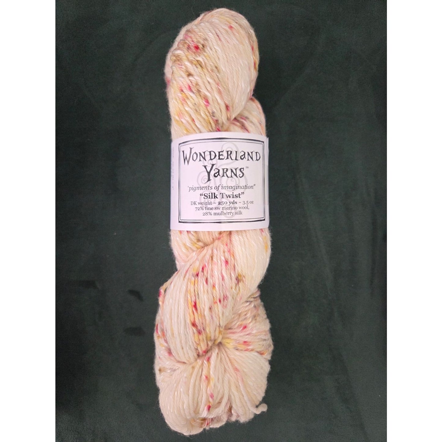 Frabjous Fibers skein of Wonderland Yarns Silk Twist hand dyed cream yarn with pink and yellow speckles