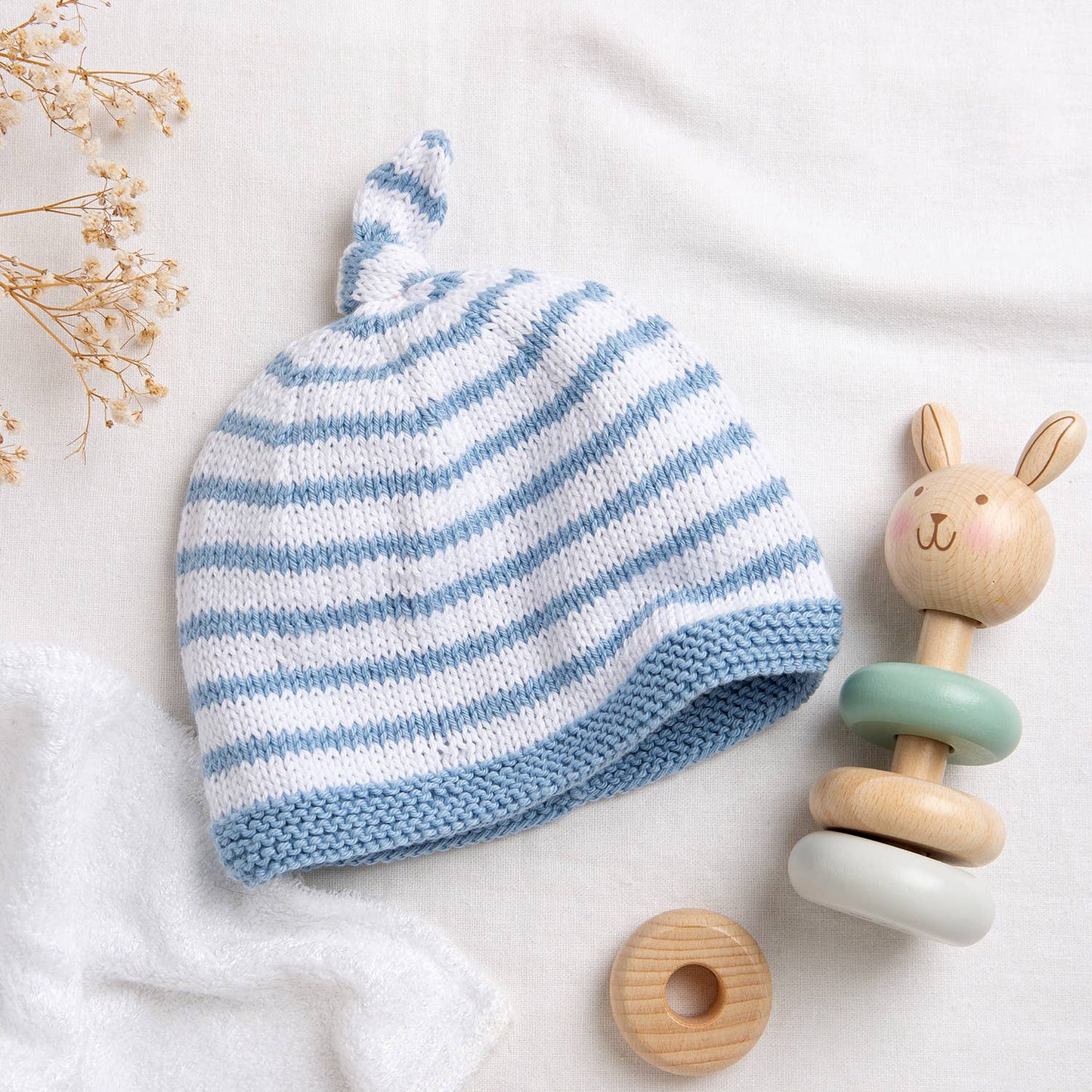 Wool Couture Company striped baby hat knitting pattern blue and white newborn beanie with top knot prop