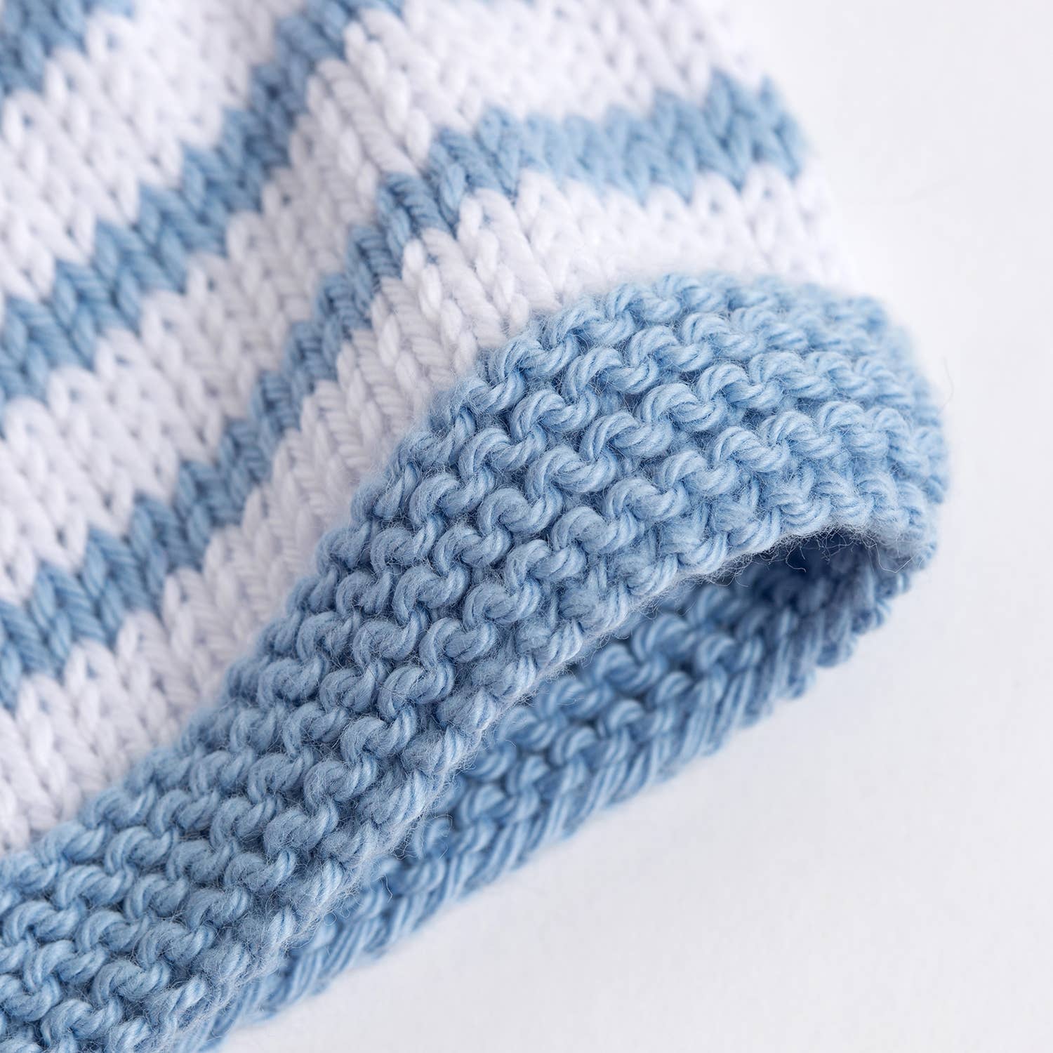 Wool Couture Company blue and white striped baby hat close up showing rolled brim and striped baby hat knitting pattern