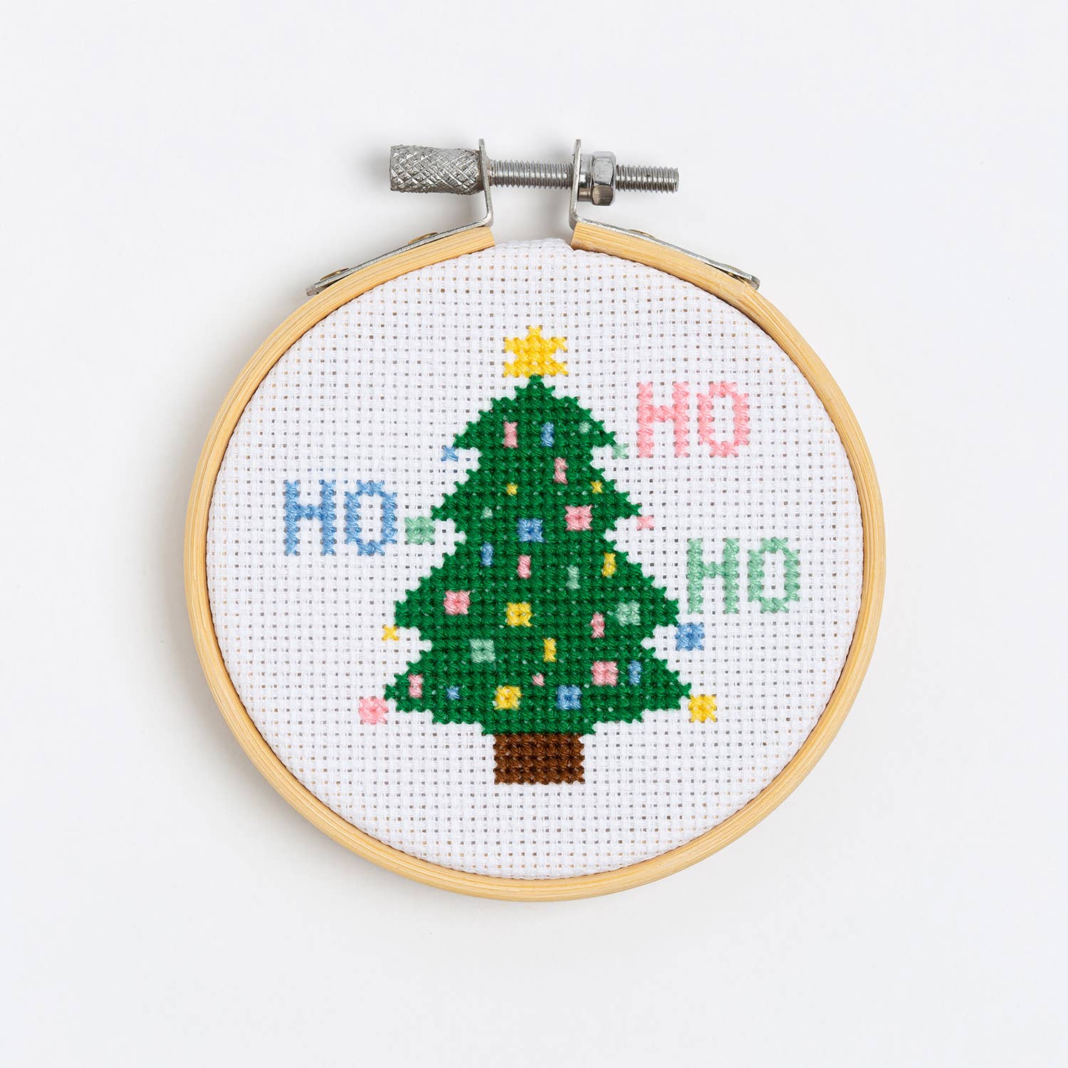 Christmas tree cross stitch kit wool couture company hoop with green tree and HO HO HO on white aida cloth